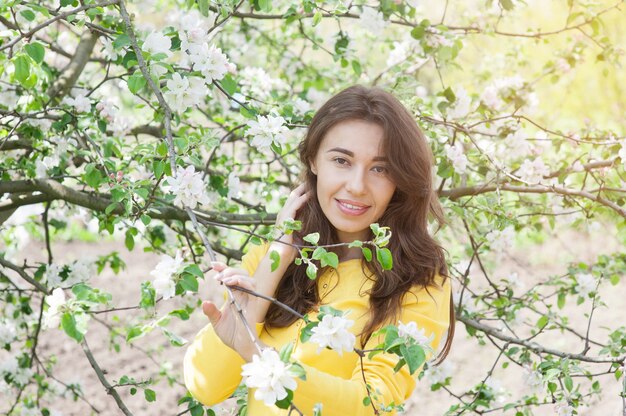 Portrait of young woman in flowered garden