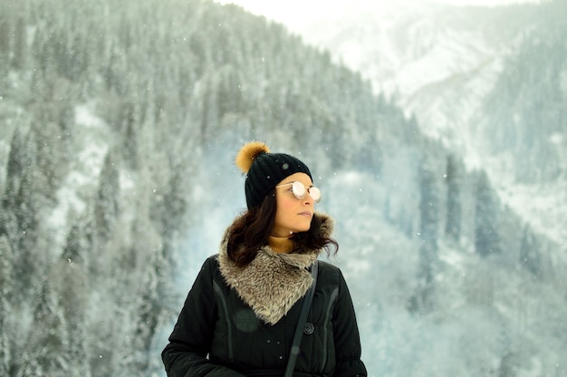 portrait of a young woman in forest in snow