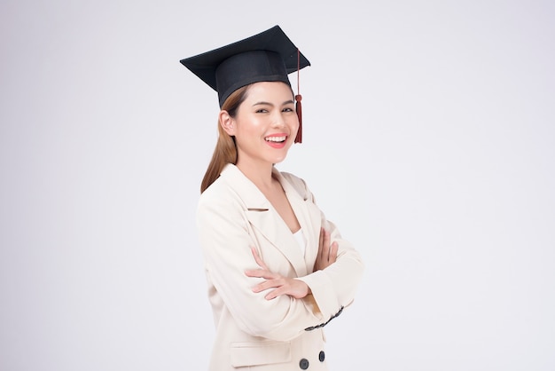 Portrait of young woman graduated over white background