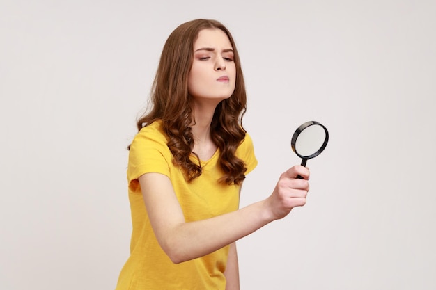 Portrait of young woman on gray background