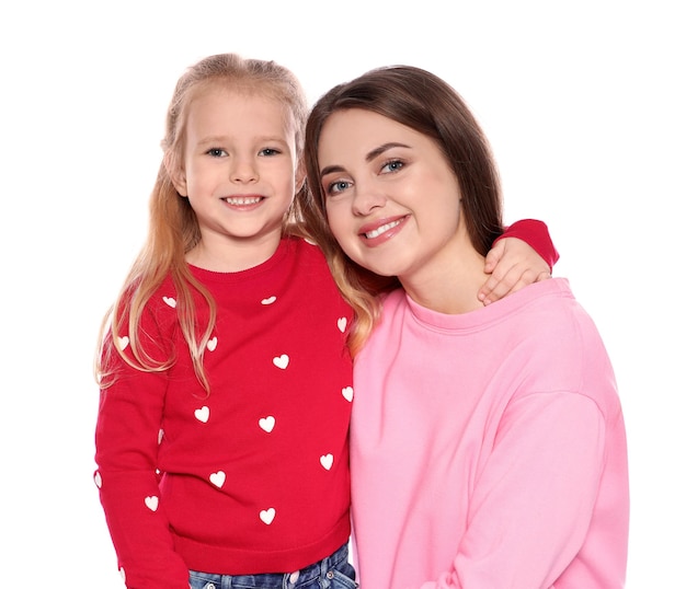 Portrait of young woman and her daughter isolated on white