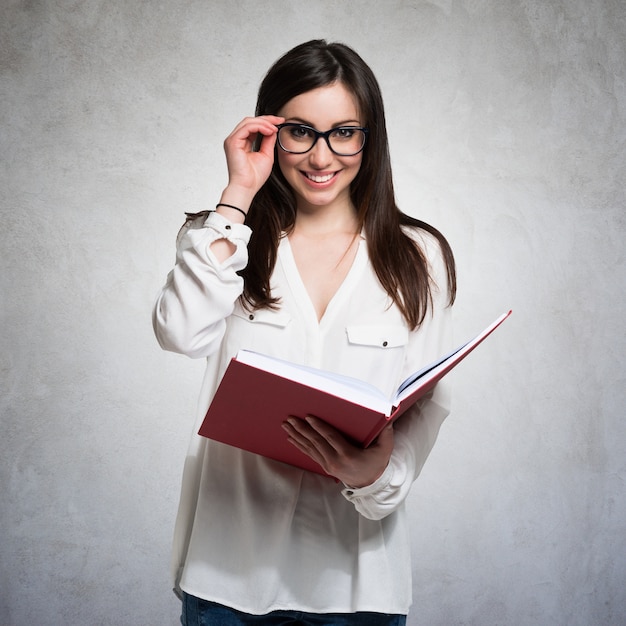 Portrait of a young woman holding a book