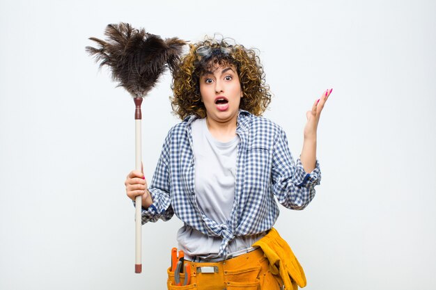 Portrait of a young woman holding a duster