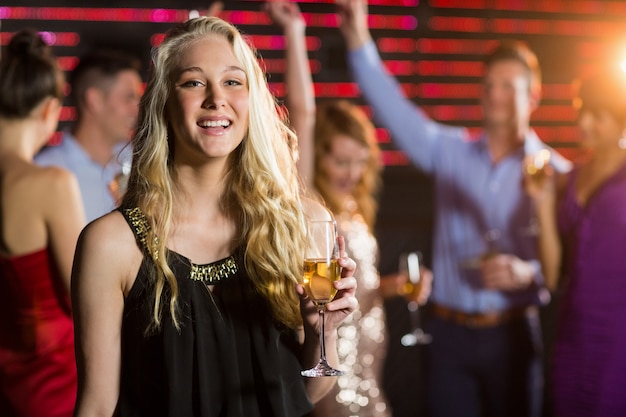 Portrait of young woman holding a glass of champagne