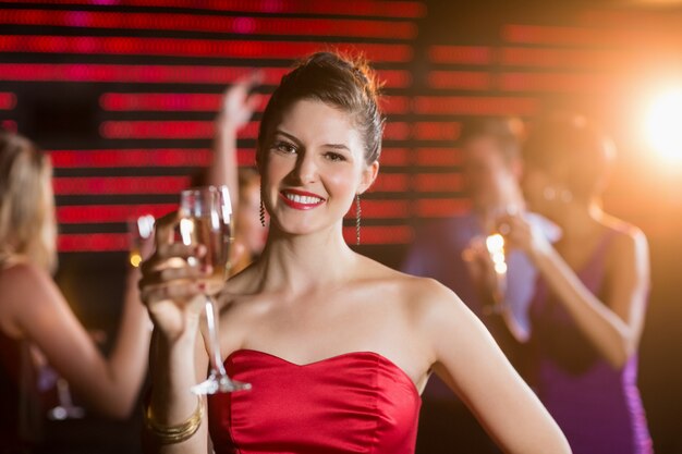 Portrait of young woman holding a glass of champagne