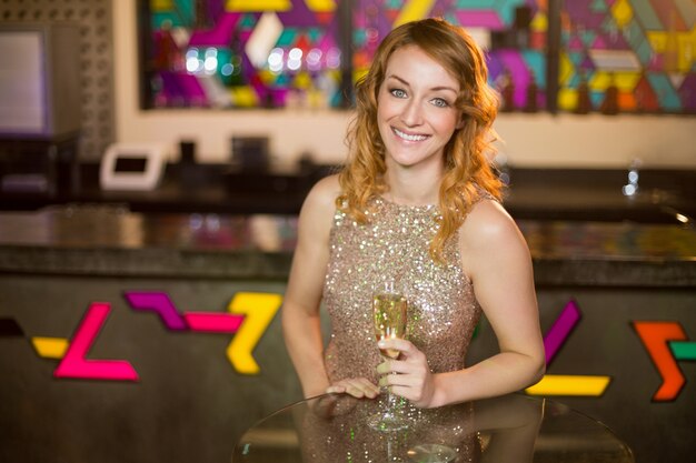 Portrait of young woman holding a glass of champagne