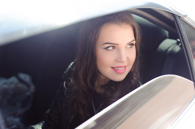 Portrait of young woman in love in a car