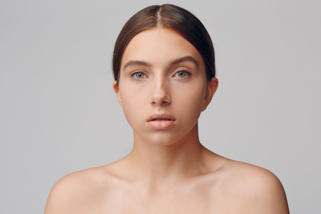 Portrait of young woman model in studio with natural make-up. Makeup concept.