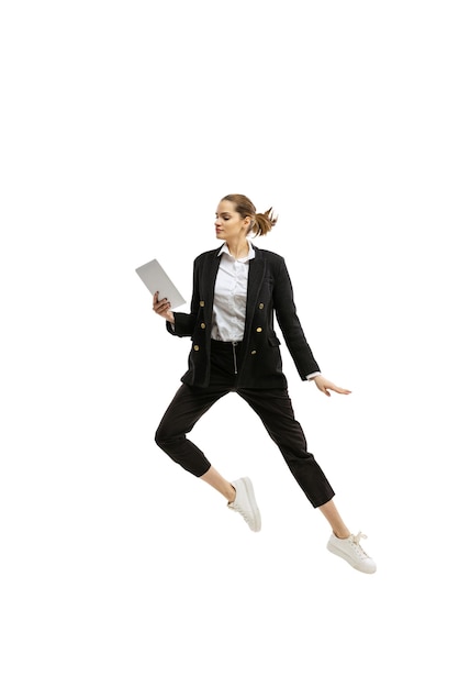 Photo portrait of young woman office worker in official cloth jumping isolated over white studio background