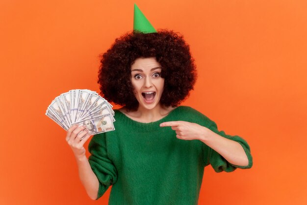 Portrait of young woman on orange background