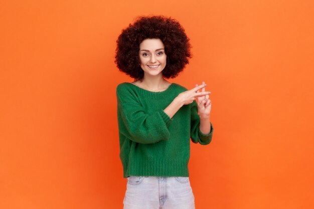 Portrait of young woman on orange background