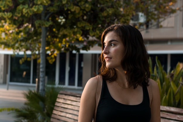 Portrait of a young woman in a park of a city