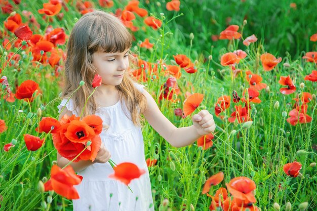 Portrait of young woman picking flowers on field