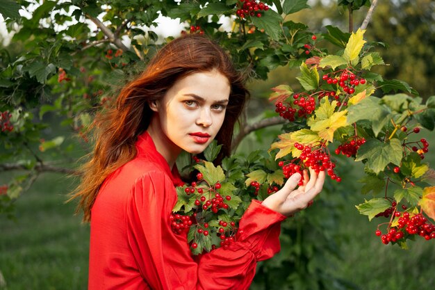 Portrait of young woman picking flowers