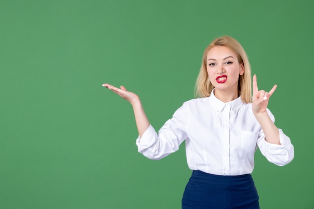 portrait of young woman posing in green wall book school student teacher college