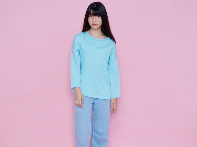 Portrait of young woman posing on pink wall