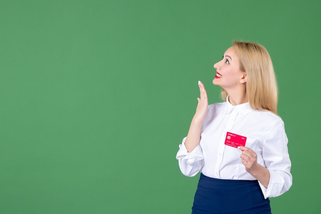 portrait of young woman posing with credit card green wall money school business bank