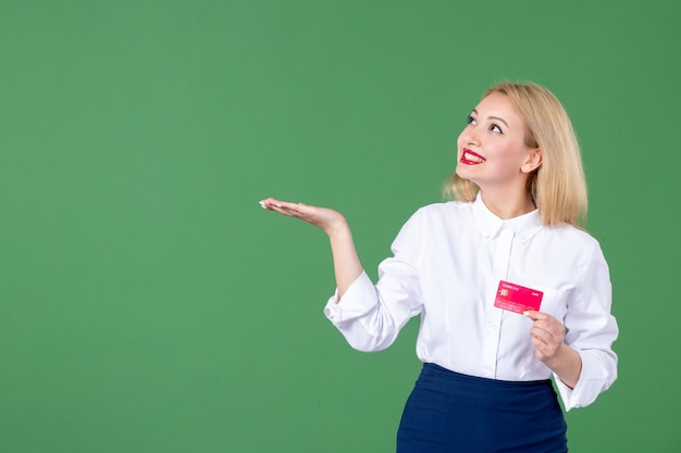 portrait of young woman posing with credit card green wall school teacher business bank