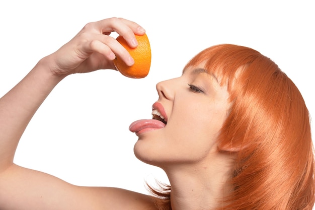 Portrait of young woman posing with oranges isolated