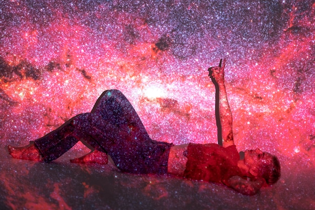 Portrait of young woman posing with universe projection texture