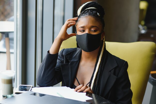 Portrait of a young woman in protective mask