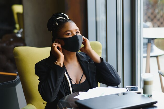 Portrait of a young woman in protective mask