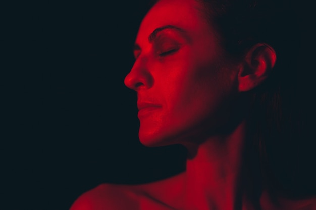 Portrait of a young woman in red light