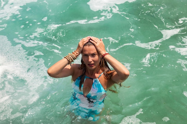 Portrait young woman relaxing at tropical coral reef beach on Indian ocean