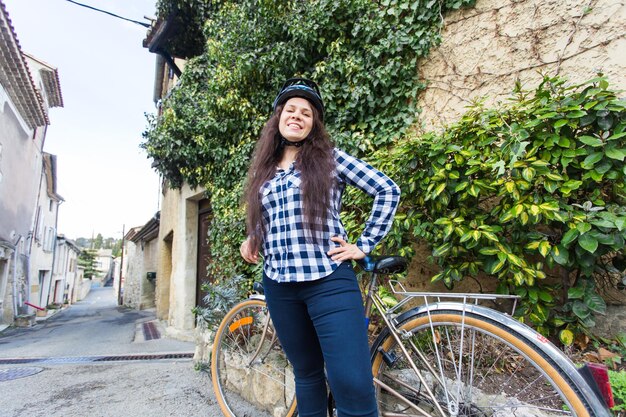 Portrait of young woman riding bicycle on street