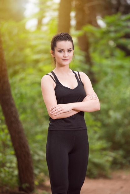 Portrait of a Young Woman Running In Wooded Forest Area  Training And Exercising For Trail Run Marathon Endurance  Fitness Healthy Lifestyle Concept