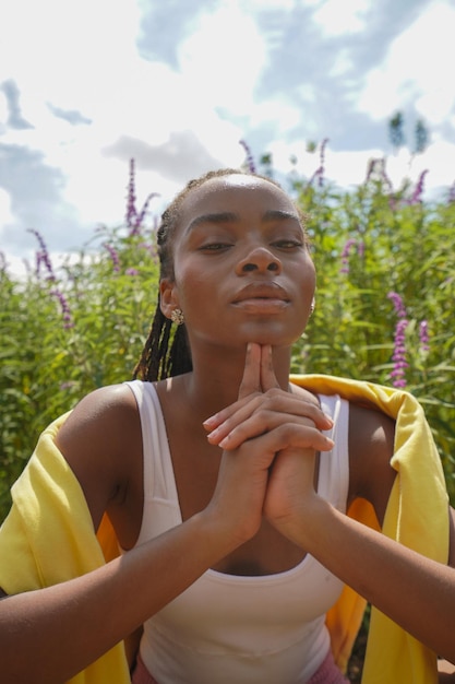 Portrait of young woman sitting against trees