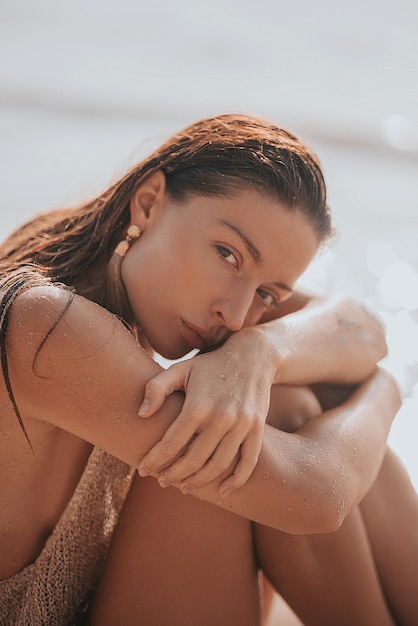 Portrait of young woman sitting on beach