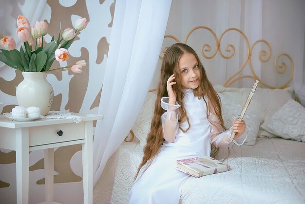 Portrait of young woman sitting on bed at home