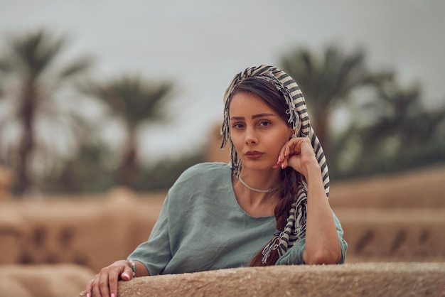 Portrait of young woman sitting on bench