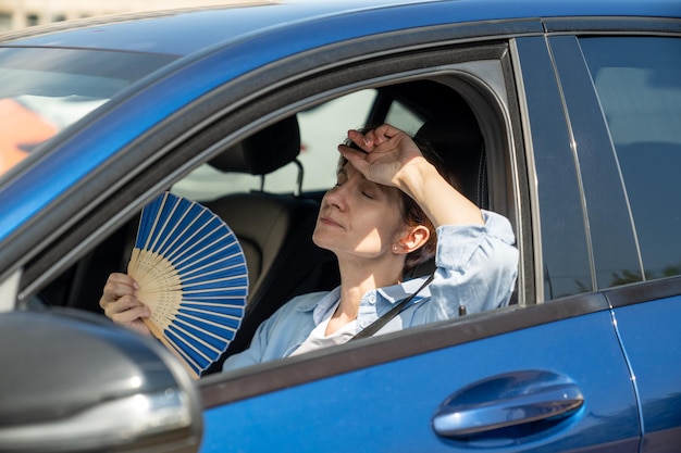 Portrait of young woman sitting in car