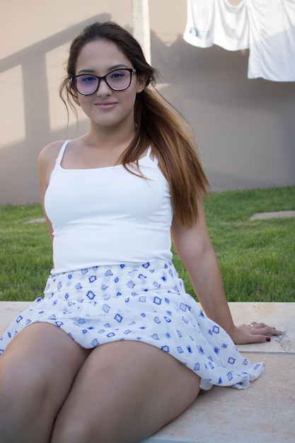 Portrait of young woman sitting in city