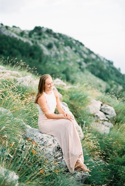 portrait of young woman sitting on field