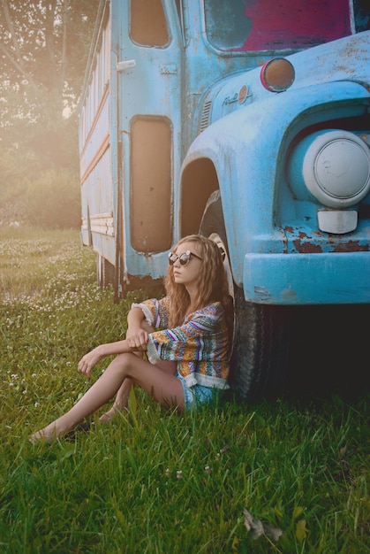portrait of a young woman sitting on grass