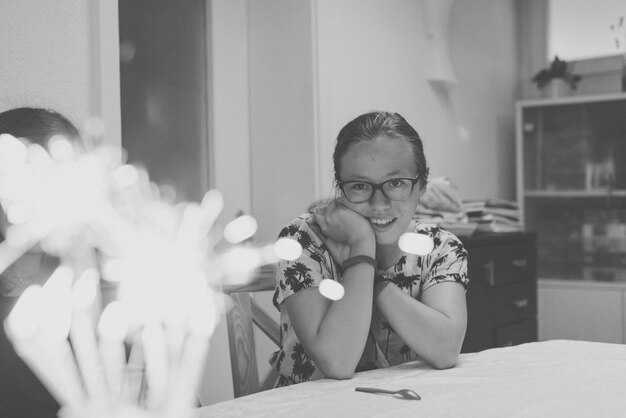 Portrait of young woman sitting at home