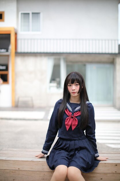 Photo portrait of young woman sitting outdoors