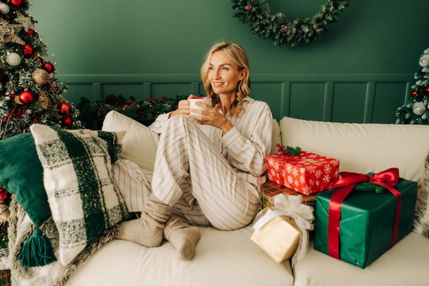 Portrait of young woman sitting on sofa at home