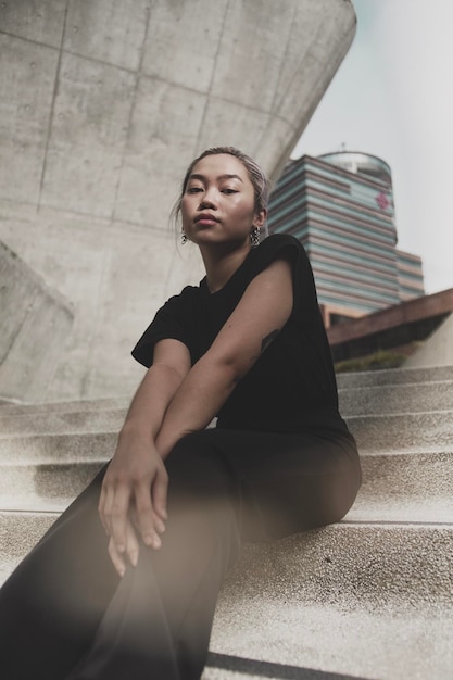portrait of young woman sitting on steps