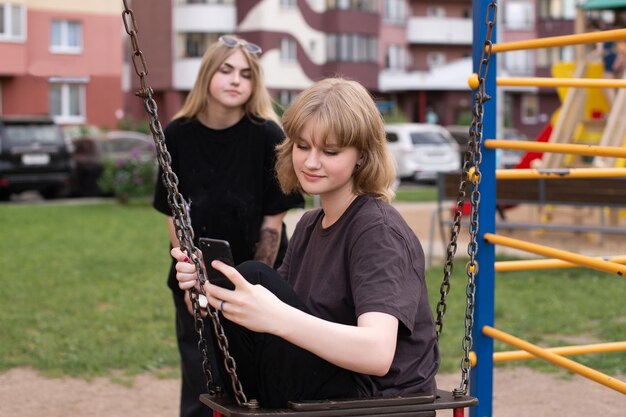 Portrait of young woman sitting on swing