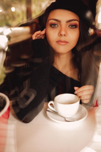 Photo portrait of young woman sitting on table