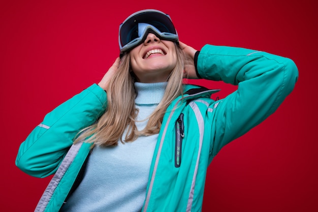 Portrait of a young woman in a ski jacket and glasses