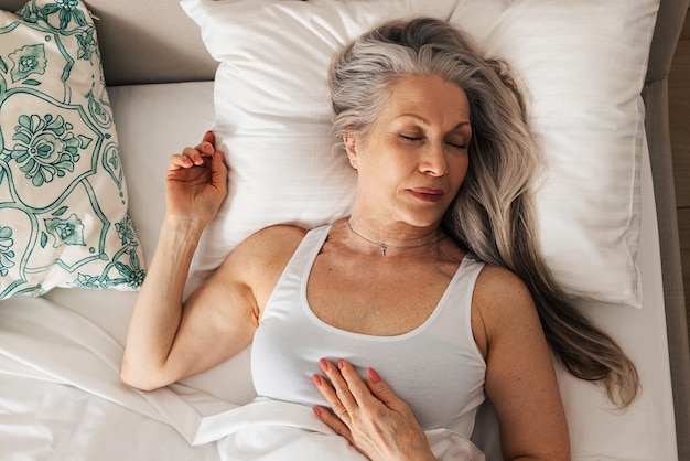 Portrait of young woman sleeping on bed at home