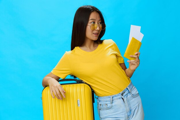 Portrait of young woman standing against blue background