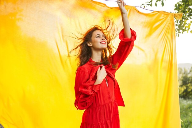 Portrait of young woman standing against orange sky