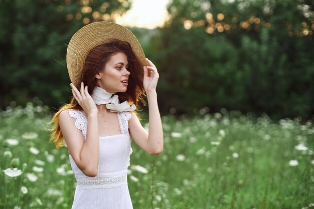 Portrait of young woman standing against plants