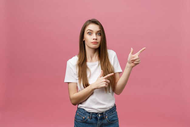 Portrait of young woman standing against red background